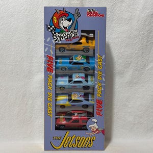May include: A box of five die-cast cars featuring characters from the cartoon show The Jetsons. The cars are yellow, blue, and red. The box has a cartoon image of a dog wearing a racing helmet and the words "Cartoon Network Racing Champions".