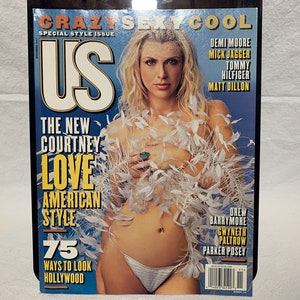 May include: A magazine cover featuring a woman in a white feathered boa with the title "US" and the text "The New Courtney Love American Style 75 Ways to Look Hollywood".