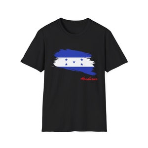 May include: Black t-shirt with a blue and white Honduran flag design. The flag is painted in a brushstroke style with the word "Honduras" written in red below it.