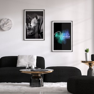 Stunning black and white portrait of a rhino set in a thin, black frame shown in a modern living room.