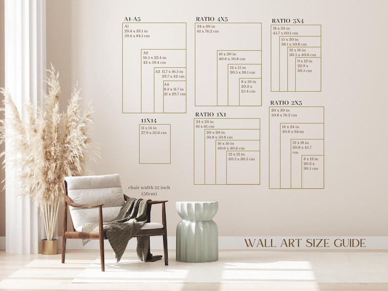 May include: A wall art size guide with different ratios and measurements in inches and centimetres. The guide shows the dimensions of various sizes of wall art, including 11x14, 4x5, 3x4, 2x3, and 1x1 ratios. The guide is displayed on a wall with a light beige colour. A chair with a light beige fabric and a light green stool are in the foreground.