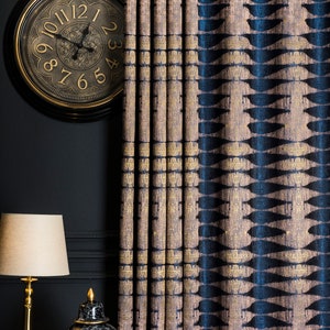 May include: A pair of black and gold decorative ceramic vases with a marbleized pattern, sitting on a black table in front of a blue and gold patterned curtain.