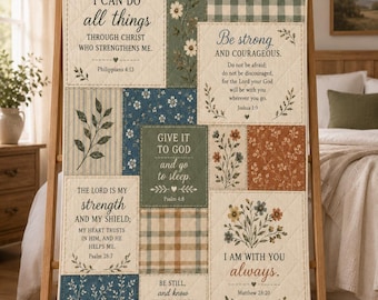 May include: A quilted throw blanket featuring a patchwork design with various floral patterns, plaid sections, and printed Bible verses including Philippians 4:13, Joshua 1:9, Psalm 4:8, Psalm 28:7, Matthew 28:20, and Psalm 46:10 in a neutral color palette.