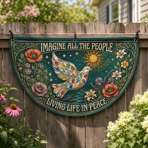 May include: A teal, semi-circular sign with the text "IMAGINE ALL THE PEOPLE" and "LIVING LIFE IN PEACE". A dove with colorful handprints is in the center, surrounded by flowers and a sun. The sign is hanging on a wooden fence.