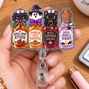 May include: A glittery acrylic badge reel featuring four potion bottles labeled Apple Crisp Ativan, Pumpkin Spice Propofol, Maple Cinnamon Haldol, and Spiced Vanilla Versed. The bottles are topped with a spider nurse, a ghost, a black cat nurse, and a cork.
