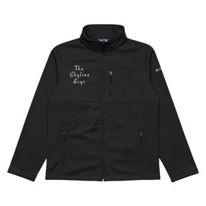 May include: Black softshell jacket with a full-length zip, two side pockets, and a chest pocket. The jacket has the text "The Skyline Boys" in white script on the left chest and a Columbia logo on the right sleeve.
