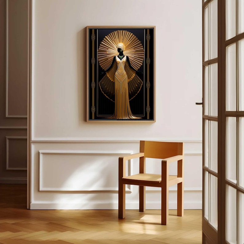 May include: A framed art print featuring a stylized gold figure with a sunburst halo against a black background. The figure is wearing a long, flowing gold dress. The artwork is displayed on a white wall, with a wooden chair in front.