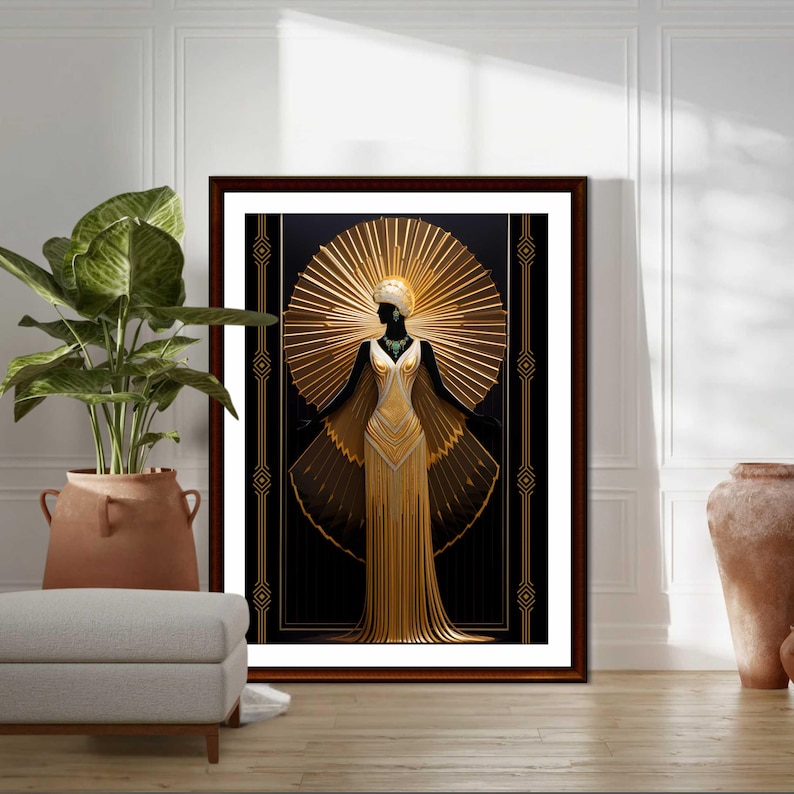 May include: A framed art print featuring a stylized figure in a gold gown with a sunburst halo against a black background. The artwork has Art Deco influences, with geometric patterns and a vintage aesthetic. The print is displayed in a room with a plant and a neutral color palette.