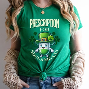 May include: Green t-shirt with a cartoon pill wearing a leprechaun hat and the text "Prescription for Shenanigans".