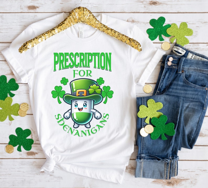 May include: White t-shirt with a green cartoon pill wearing a green leprechaun hat and the text "Prescription for Shenanigans".