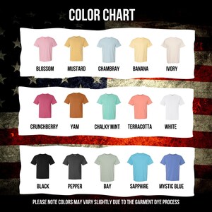 May include: Color chart showing 12 different t-shirt colors. The colors are: Blossom, Mustard, Chambray, Banana, Ivory, Crunchberry, Yam, Chalky Mint, Terracotta, White, Black, Pepper, Bay, Sapphire, and Mystic Blue. The text "PLEASE NOTE COLORS MAY VARY SLIGHTLY DUE TO THE GARMENT DYE PROCESS" is at the bottom of the chart.