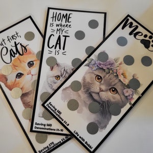 May include: Three scratch-off cards with cat illustrations and the text "But first, Cats", "Home is where my cat is", and "Meow". Each card has silver circles that can be scratched off to reveal a prize.