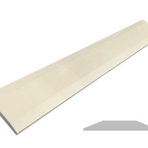 May include: A long, off-white, rectangular tile with a slightly rounded edge. The tile has a subtle, textured surface.