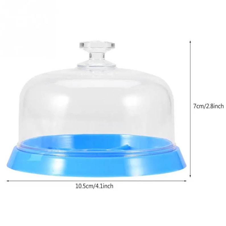 May include: A clear plastic dome with a blue base and a small knob on top. The dome is 7 inches tall and the base is 10.5 inches in diameter.
