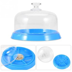 May include: A clear plastic dome with a blue base and a removable tray with compartments. The tray has a small watch movement inside one of the compartments.