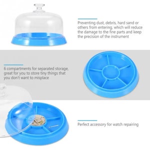 May include: A blue watch repair tray with a clear dome cover. The tray has six compartments for storing small parts. The tray is on a white background. Preventing dust, debris, hard sand or others from entering, which will reduce the damage to the fine parts and keep the precision of the instrument.