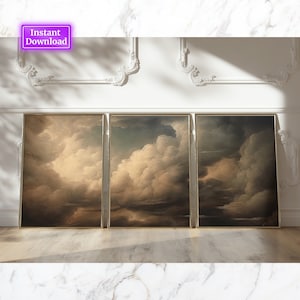 May include: Three framed cloudscape art prints with gold frames. The artwork features a dramatic depiction of clouds in shades of brown, beige, and gray. The phrase "Instant Download" is in a purple box in the upper left corner.