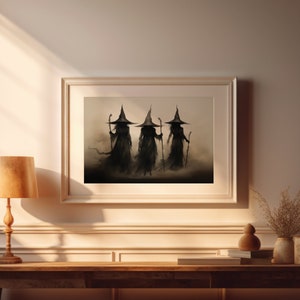 May include: A framed print of three witches in black robes and pointed hats walking in a misty forest. The witches are silhouetted against a light background.