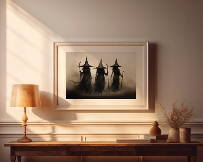 May include: A framed print of three witches in black robes and pointed hats walking in a misty forest. The witches are silhouetted against a light background.