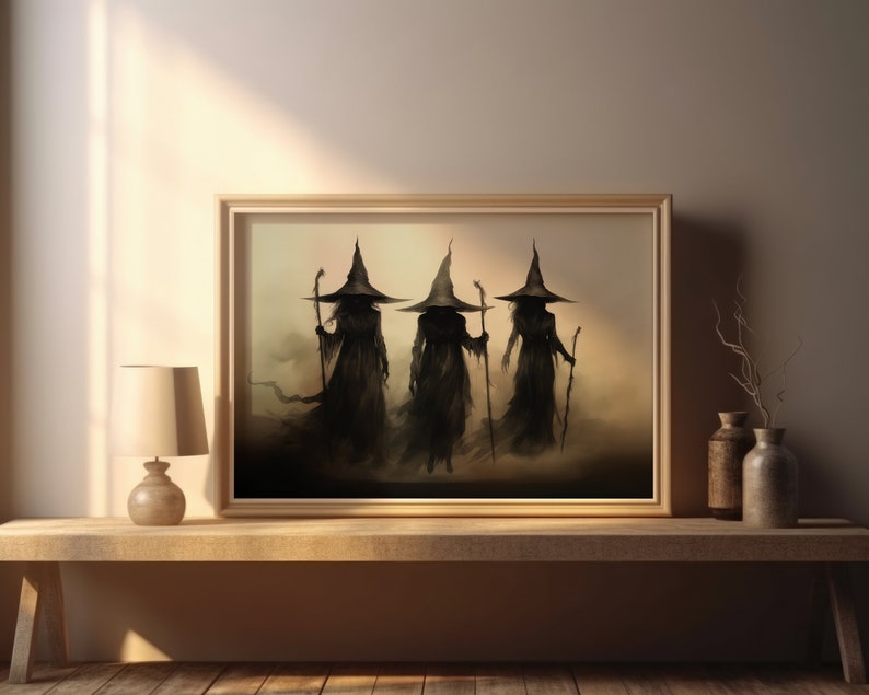 May include: A framed print of a fantasy illustration depicting three cloaked figures wearing pointed hats and holding staffs. The figures are walking through a misty, ethereal landscape.