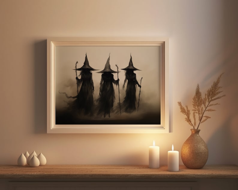 May include: A framed print of three witches in black robes and pointed hats walking in a misty forest. The witches are silhouetted against a light background.