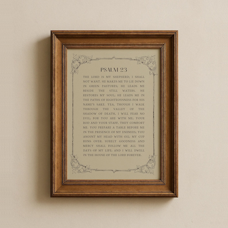 May include: A framed print displaying the text of Psalm 23. The text is in a traditional serif font, set against a light beige backdrop. The frame is a warm, medium brown, and the print is suitable for home decor.
