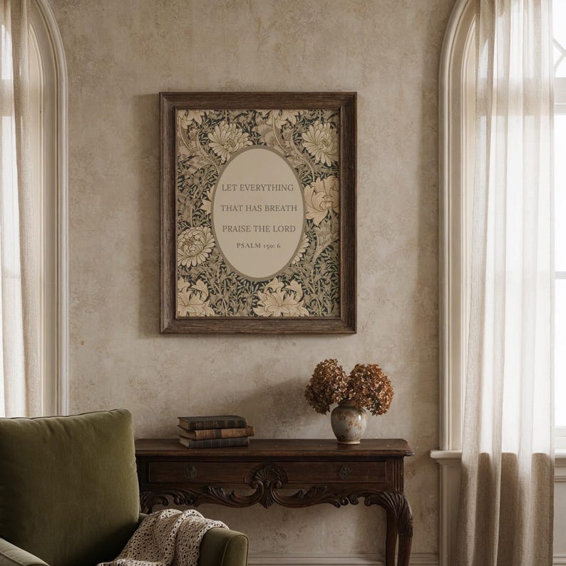May include: A framed print with a floral design and the text "LET EVERYTHING THAT HAS BREATH PRAISE THE LORD PSALM 150:6". The frame is dark brown. The text is in a light oval shape. The print is hanging on a wall.
