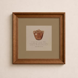 May include: A framed print featuring a watercolor illustration of a brown, lidded pot. The artwork includes text from Isaiah 64:8, set against a beige background, within a brown wooden frame. The overall theme is religious and inspirational.