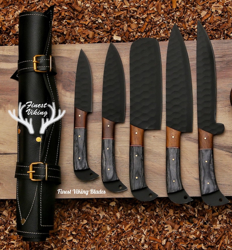 May include: A set of six black kitchen knives with wooden handles, arranged on a wooden surface. The knives are all different sizes and shapes, and they are all very sharp. The knives are labelled "Finest Viking Blades".