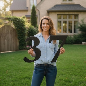 Custom black metal house numbers displayed outdoors, modern durable address sign for home