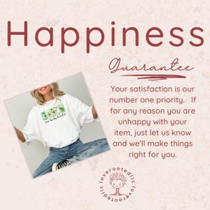 May include: White t-shirt with a green graphic and the text "one lucky teacher." The word "Happiness" is at the top of the image in a burgundy color. The image also includes a guarantee.