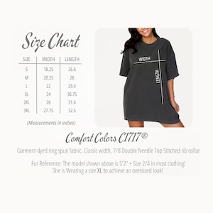 May include: A dark grey t-shirt with a size chart showing measurements in inches. The chart includes sizes S to 3XL, with widths from 46.35 cm to 70.49 cm and lengths from 67.56 cm to 82.55 cm. The shirt is Comfort Colors C1717&reg;.