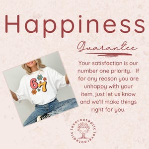 May include: White t-shirt with a retro floral graphic featuring the numbers 6 and 7. The word "Happiness" is displayed in a burgundy font at the top. The image also includes the text "Guarantee".