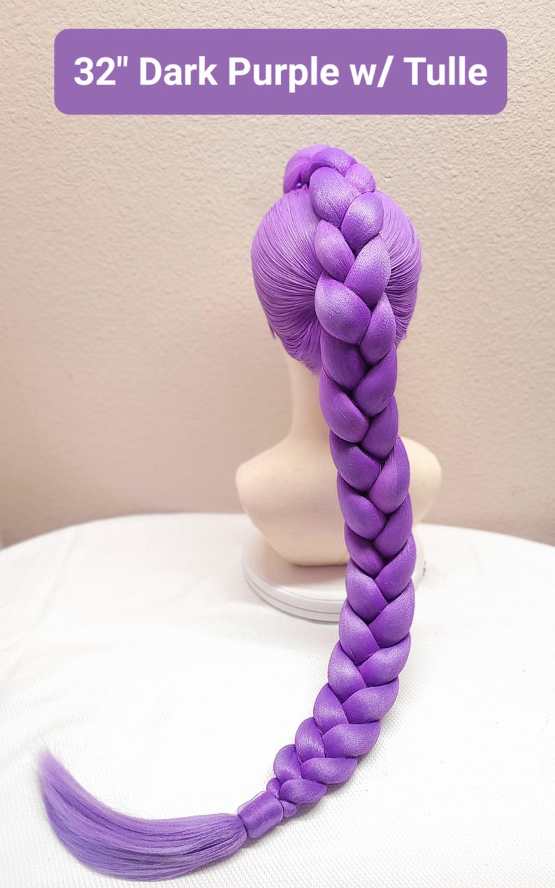 May include: A 32-inch dark purple synthetic hair extension styled in a thick, single braid on a mannequin head. The hair is smooth and vibrant, featuring a long, braided ponytail that extends downward, ending in a loose, straight section of hair.