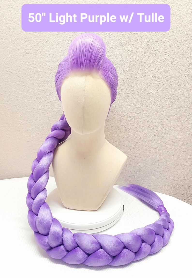 May include: A 50-inch light purple wig styled with a high bun and a long, thick braid that drapes forward. The wig is displayed on a mannequin head and features the text 50" Light Purple w/ Tulle at the top of the frame.