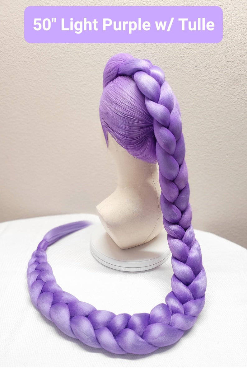 May include: A 50-inch light purple wig styled with a long, thick, single braid that extends from the crown of the head down to the base. The wig features smooth, straight hair fibers at the top and a large, uniform plait. Text reads 50" Light Purple w/ Tulle.