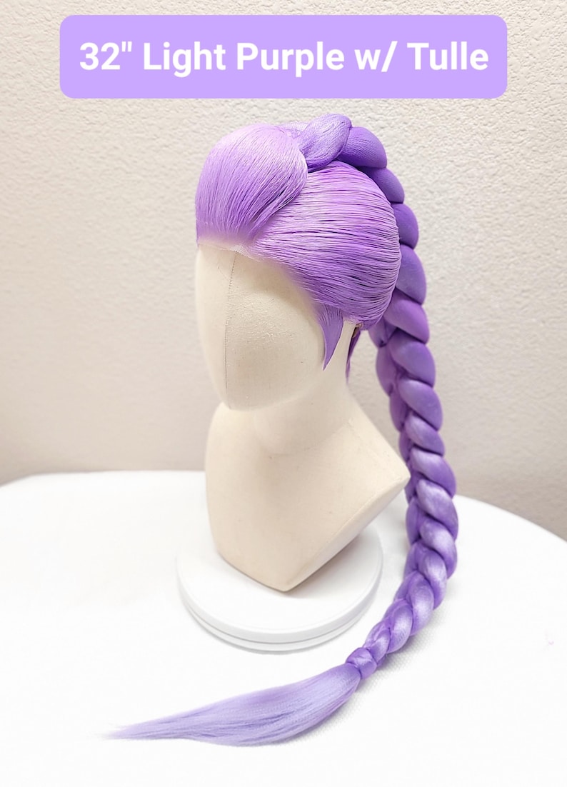 May include: A 32-inch light purple wig styled with a long, thick, single braid extending from the crown. The hair features a smooth, swept-back front section and a vibrant violet hue. The text 32" Light Purple w/ Tulle is visible at the top.