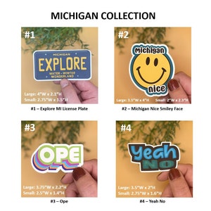 May include: Four different sticker designs featuring Michigan-themed imagery. The first sticker is a blue license plate with the text "MICHIGAN EXPLORE WATER-WINTER WONDERLAND". The second sticker is a yellow smiley face with the text "Michigan nice". The third sticker is a multi-colored word "OPE" in a retro font. The fourth sticker is a black and white word "Yeah NO" in a retro font.