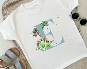 Camiseta de niño de manga corta animal personalizada de dinosaurio. Niños/niñas/unisex, 3 colores/diseños disponibles. Ilustraciones originales e inicial.