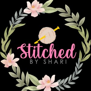 May include: A pink floral wreath with a ball of yarn and knitting needles in the center. The text "Stitched by Shari" is written in pink below the yarn.