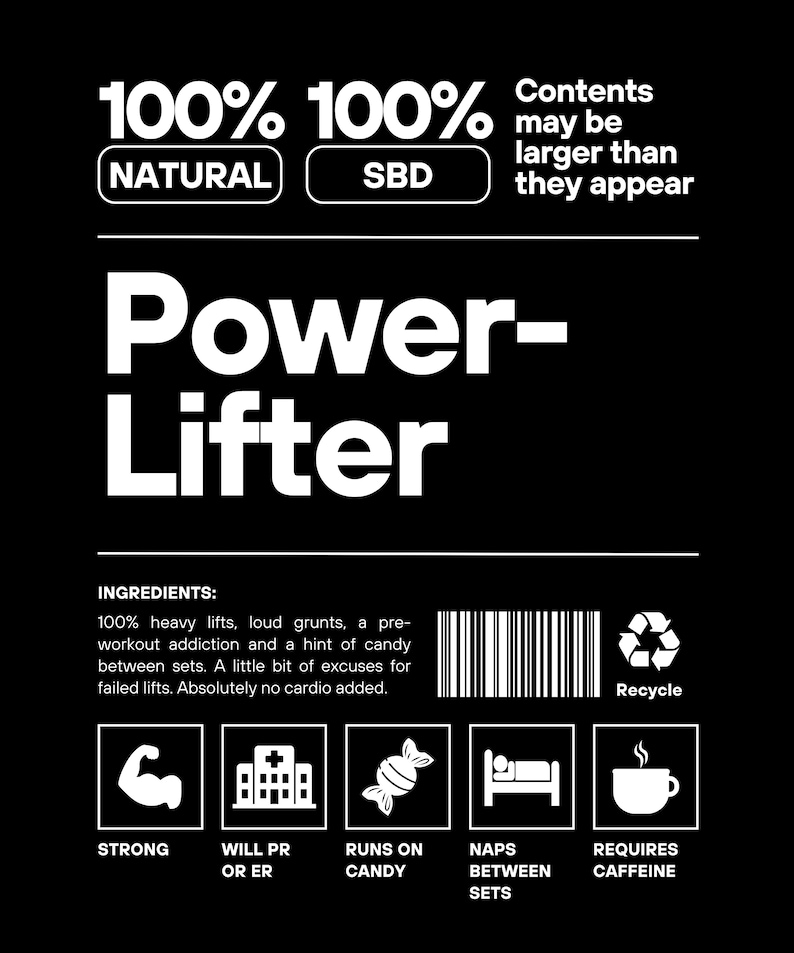 May include: A black and white illustration of a powerlifter with the text "100% 100% NATURAL SBD" and "Contents may be larger than they appear". The illustration includes a barbell, weights, and a powerlifter in a lifting pose. The text "Power-Lifter" is in a large font at the top of the image. The text "INGREDIENTS" is followed by a list of ingredients: "100% heavy lifts, loud grunts, a pre-workout addiction and a hint of candy between sets. A little bit of excuses for failed lifts. Absolutely no cardio added."