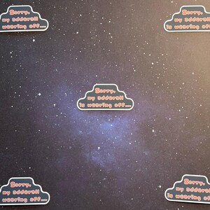 May include: Five cloud-shaped stickers with the text "Sorry, my adderall is wearing off..." in red lettering. The stickers have a black outline and a white border. The background is a dark, starry sky.