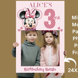 May include: Pink Minnie Mouse themed birthday party photo booth prop frame with a picture of two children. The frame says "Alice's 3rd Birthday Bash" and measures 24x36 inches.