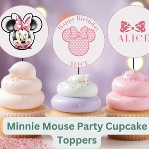 May include: Three pink and white cupcake toppers featuring Minnie Mouse. The toppers have a pink bow, a pink polka dot bow, and a pink polka dot head with ears. The toppers say "Happy Birthday Alice" and "Alice".