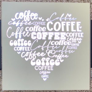 May include: A white heart-shaped design with the word "coffee" repeated in various fonts and sizes. The word "coffee" is repeated 15 times in the design.