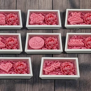 a bunch of pink roses in a white box