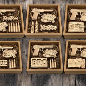 a set of six wooden toy guns in a box