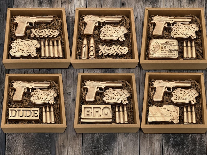 a set of six wooden toy guns in a box