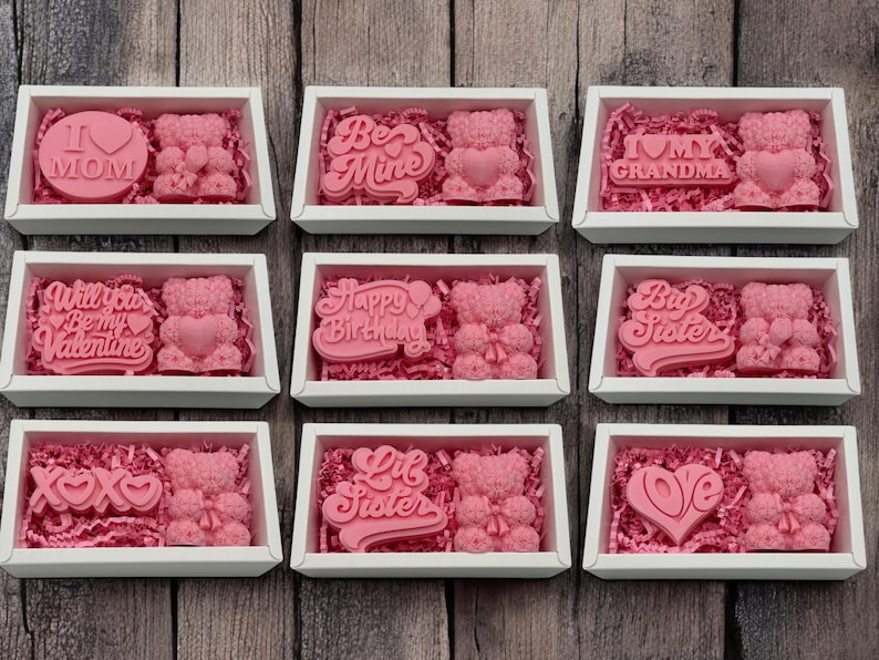 a bunch of pink candies in a white box