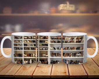 May include: White ceramic mug with a detailed image of a white bookshelf filled with miniature horse figurines. The horses are in various colours and poses. The mug is set on a wooden surface with a blurred background.